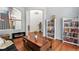 Cozy living room with hardwood floors, a modern fireplace, and open archways leading to other living spaces at 9530 E 113Th Ave, Commerce City, CO 80640