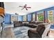 Comfortable living room with a fireplace, ceiling fans, and large sectional sofa at 9530 E 113Th Ave, Commerce City, CO 80640