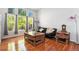 Bright living room featuring hardwood floors, a comfortable sofa, and large windows offering plenty of natural light at 9530 E 113Th Ave, Commerce City, CO 80640