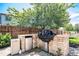 A built-in grill with stainless steel appliances is set within a brick surround in this spacious backyard at 9530 E 113Th Ave, Commerce City, CO 80640