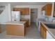 This spacious kitchen features ample cabinet space, an island, and newer vinyl flooring at 10966 Josephine St, Northglenn, CO 80233