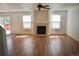 Bright living room with a fireplace, stylish flooring, and slider door access to deck at 10966 Josephine St, Northglenn, CO 80233