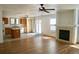 Open concept living space featuring a fireplace, modern flooring, and kitchen area at 10966 Josephine St, Northglenn, CO 80233