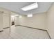 Finished basement area with tiled floor, neutral walls and trim, and recessed lighting at 755 S Clay St, Denver, CO 80219