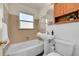 Bathroom featuring a sink and bathtub with tiled walls and neutral color scheme at 755 S Clay St, Denver, CO 80219