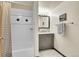 Bathroom featuring a tiled shower, vanity, and mirror; stylish and functional at 755 S Clay St, Denver, CO 80219