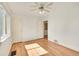 Bright bedroom features hardwood floors, ceiling fan, and view of neighborhood from window at 755 S Clay St, Denver, CO 80219