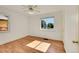 Bright bedroom features hardwood floors, ceiling fan, and view of neighborhood from window at 755 S Clay St, Denver, CO 80219