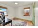 Bedroom with a desk and colorful rug, with natural light coming through the windows at 755 S Clay St, Denver, CO 80219