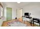 Bedroom with a desk and colorful rug, with natural light coming through the windows at 755 S Clay St, Denver, CO 80219