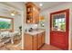 Cozy eat-in kitchen area with bright red door and connecting dining space at 755 S Clay St, Denver, CO 80219