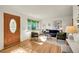 Cozy living room with stylish furnishings, warm hardwood floors, and ample natural light from a large window at 755 S Clay St, Denver, CO 80219