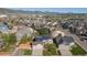 An aerial view of the house showing the solar panels on the roof and surrounding neighborhood at 9525 W Victoria Dr, Littleton, CO 80128