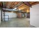 Spacious unfinished basement with concrete floor, exposed ceiling and framing ready for personalization at 9525 W Victoria Dr, Littleton, CO 80128
