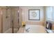Bathroom featuring a shower, a tub, and decor at 9525 W Victoria Dr, Littleton, CO 80128