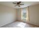 Empty bedroom with carpet flooring, a ceiling fan, and a window with curtains at 9525 W Victoria Dr, Littleton, CO 80128