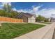View of the home's exterior featuring solar panels, a side-entry garage, and well-kept lawn at 9525 W Victoria Dr, Littleton, CO 80128
