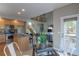Open concept kitchen with stainless appliances, an island, and hardwood floors flowing into the living area at 9525 W Victoria Dr, Littleton, CO 80128