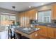 Kitchen with an island, stainless steel appliances, wooden cabinetry, and lots of storage at 9525 W Victoria Dr, Littleton, CO 80128