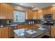 Kitchen featuring stainless steel appliances, granite counters and wooden cabinetry at 9525 W Victoria Dr, Littleton, CO 80128