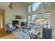 Cozy living room featuring a fireplace, large windows, and comfortable seating at 9525 W Victoria Dr, Littleton, CO 80128