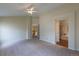 Spacious bedroom with carpet flooring, a ceiling fan, and doorways to other rooms at 9525 W Victoria Dr, Littleton, CO 80128
