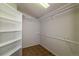 Walk-in closet with built-in shelving, tile floors, and rod hangers at 9525 W Victoria Dr, Littleton, CO 80128