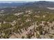 Breathtaking aerial view of a home surrounded by trees, emphasizing its privacy and integration with the picturesque natural landscape at 12672 Rancho Ct, Conifer, CO 80433