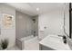 Modern bathroom with sleek gray tiles, glass-enclosed shower, and a window offering natural light at 12672 Rancho Ct, Conifer, CO 80433