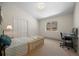 Bright bedroom featuring a comfortable bed, desk, closet, and a window with views of the surrounding nature at 12672 Rancho Ct, Conifer, CO 80433