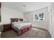 Relaxing bedroom with a queen-size bed, carpet floors, and a window looking out at nature at 12672 Rancho Ct, Conifer, CO 80433