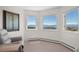 Bedroom with large windows overlooking picturesque mountain views and natural light at 12672 Rancho Ct, Conifer, CO 80433