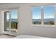 Bedroom with sliding glass door access to a deck, plus large windows showcasing mountain views at 12672 Rancho Ct, Conifer, CO 80433