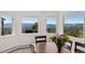 Bright dining room showcasing mountain views from large windows and hardwood floors at 12672 Rancho Ct, Conifer, CO 80433