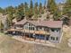 This multi-level mountain home features sprawling decks, an outdoor living area and scenic views of the surrounding mountains at 12672 Rancho Ct, Conifer, CO 80433