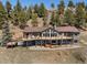 Stunning multi-level home features expansive decks, perfect for enjoying the surrounding mountain views and outdoor living at 12672 Rancho Ct, Conifer, CO 80433