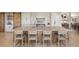 Kitchen featuring a large island, bar seating, modern appliances, and a wood sliding barn door at 12672 Rancho Ct, Conifer, CO 80433
