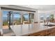 Kitchen island with quartz countertops, a sink and a deck overlooking trees and distant mountains at 12672 Rancho Ct, Conifer, CO 80433