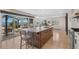 Open kitchen with an island and a deck, showcasing bright natural light and mountain views at 12672 Rancho Ct, Conifer, CO 80433