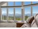 Bright living room with a large picture window offering scenic mountain views and a comfortable leather sofa at 12672 Rancho Ct, Conifer, CO 80433
