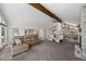 Open-concept living room with fireplace flowing into kitchen, and offering scenic mountain views at 12672 Rancho Ct, Conifer, CO 80433