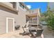 Backyard featuring a stone patio with seating and upper deck with stairs at 11367 S Blackthorn Ct, Parker, CO 80134