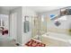 Bathroom featuring a glass-enclosed shower, soaking tub, and ceramic tile at 11367 S Blackthorn Ct, Parker, CO 80134