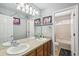 Bathroom featuring a double sink vanity and a view into the toilet and shower at 11367 S Blackthorn Ct, Parker, CO 80134