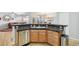 Kitchen featuring a peninsula with dark granite countertops, stainless steel appliances, and stylish wooden cabinets at 11367 S Blackthorn Ct, Parker, CO 80134