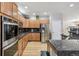 The kitchen features stainless appliances, granite countertops, and wood cabinets that seamlessly blend style with function at 11367 S Blackthorn Ct, Parker, CO 80134