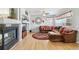 Comfortable living room featuring a fireplace, a TV area, and hardwood floors at 11367 S Blackthorn Ct, Parker, CO 80134