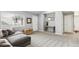 Spacious living area with a gray sectional, wood accents, neutral walls, and carpet flooring creating a cozy atmosphere at 11367 S Blackthorn Ct, Parker, CO 80134