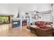 Cozy living room with a fireplace, a large sectional sofa, and hardwood floors at 11367 S Blackthorn Ct, Parker, CO 80134