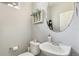 A well-lit powder room with a decorative mirror, a stylish sink, and neutral decor offers a clean and simple design at 11367 S Blackthorn Ct, Parker, CO 80134
